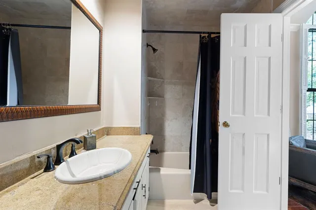 a bedroom with furniture and a window