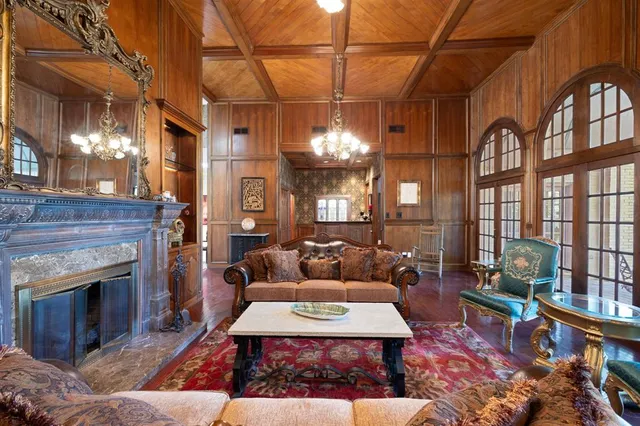 a living room with furniture a large window and stainless steel appliances