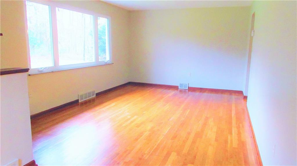 208 Steppland Road Butler, PA 16002 - Photo 2 of 25 The living room offers plenty of room, hardwood flooring and a large picture window allowing lots of natural light.