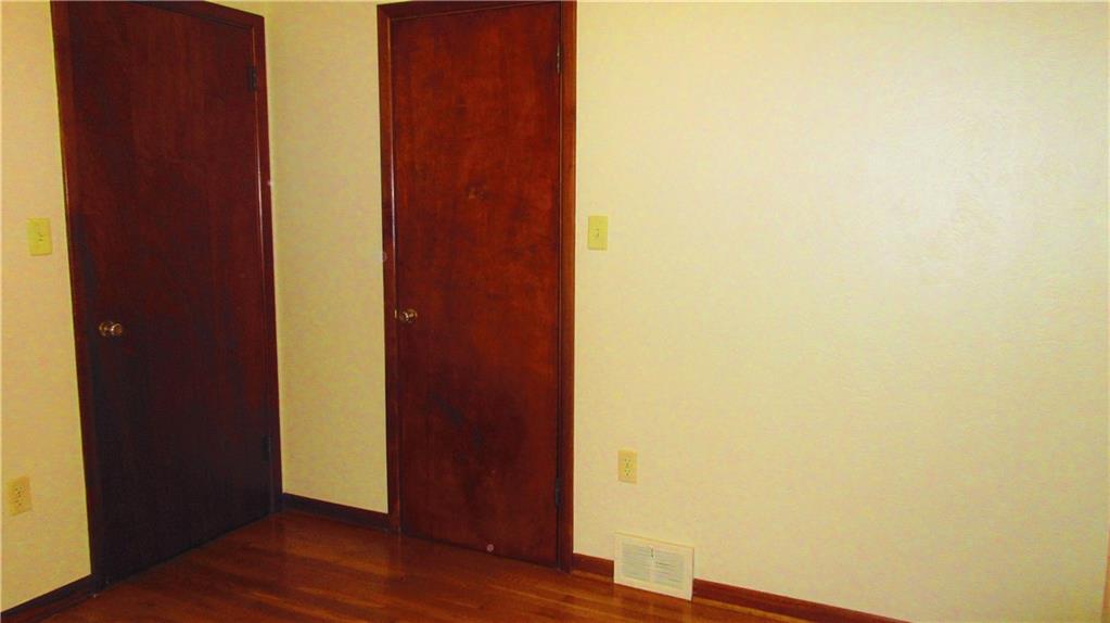 208 Steppland Road Butler, PA 16002 - Photo 11 of 25 Second bedroom has a single closet and original wood doors and wood trim.