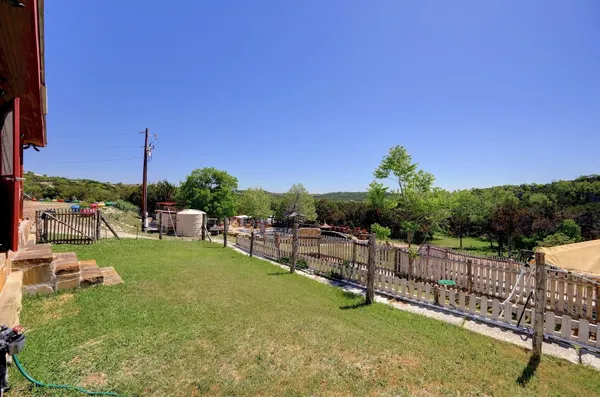a view of a backyard with sitting area