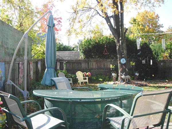 22 Santa Barbara Street Springfield, MA 01104 - Photo 18 of 23 a view of house with backyard outdoor seating and tree