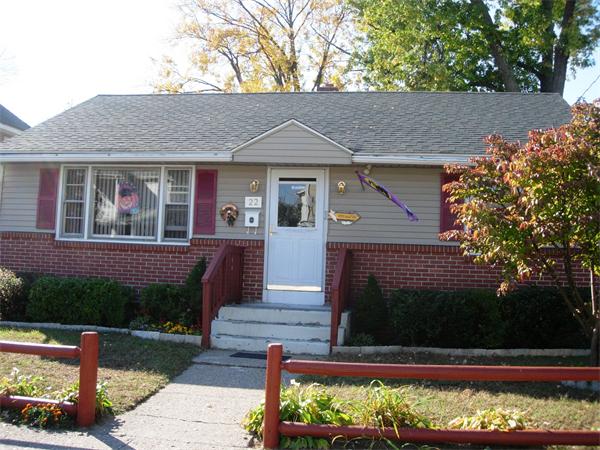22 Santa Barbara Street Springfield, MA 01104 - Photo 2 of 23 a front view of a house with a yard and a garden