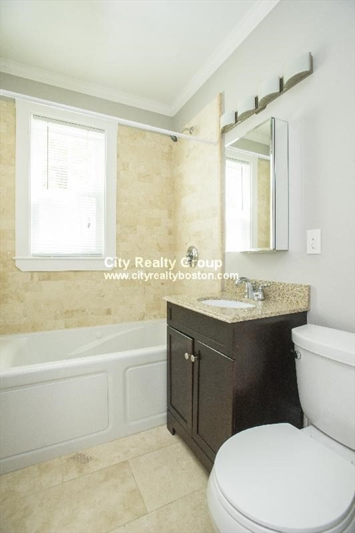 2969 Washington Street, Unit 3 Boston, MA 02119 - Photo 4 of 6 a bathroom with a sink a toilet and a bathtub