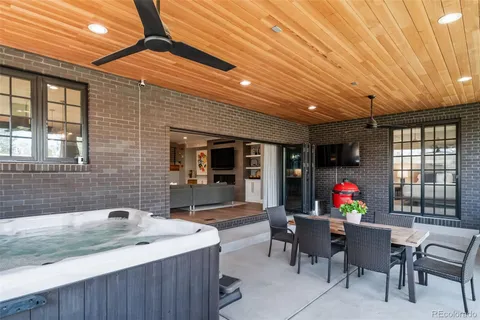 a view of a dining room with furniture large windows and wooden floor