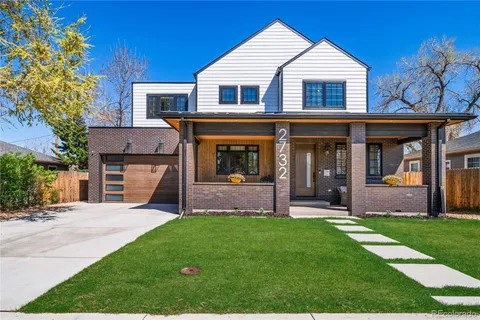 a front view of a house with a yard and porch