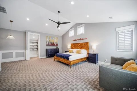 a bedroom with a bed and ceiling fan
