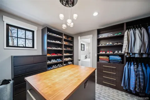 a bedroom with a bed a flat screen tv and a window