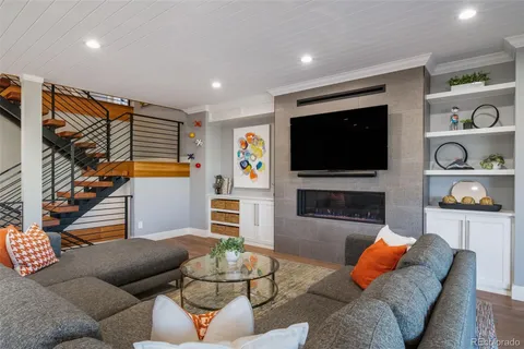 a living room with furniture kitchen view and a large window