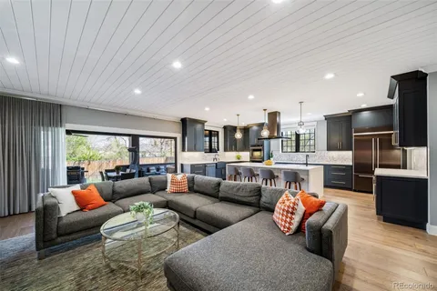 a kitchen with wooden floor and stainless steel appliances