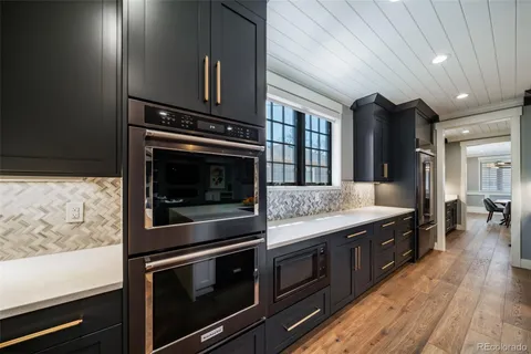 a kitchen with stainless steel appliances granite countertop a stove and a refrigerator