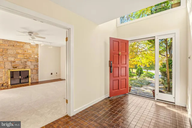 a living room with furniture and a painting on the wall
