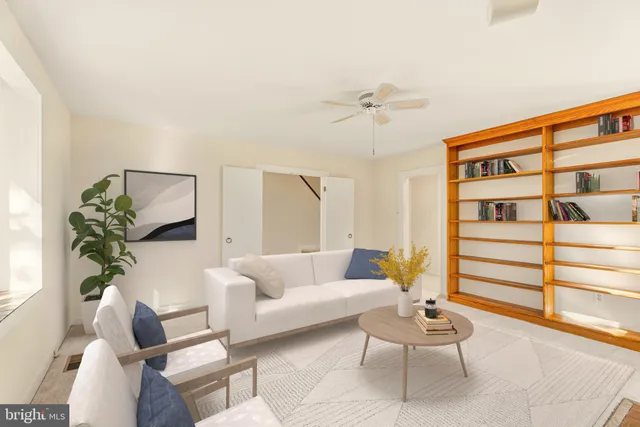 a view of livingroom with furniture fireplace ceiling fan and window