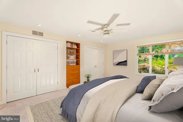 a bathroom with a tub a sink and a large window