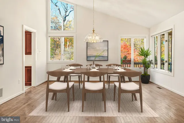 a living room with furniture a flat screen tv and a large window