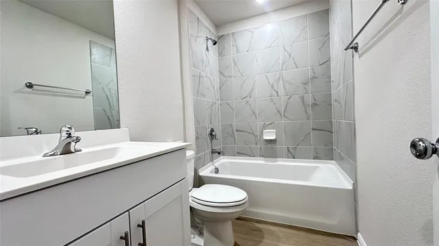 a bathroom with a sink a toilet and a bathtub