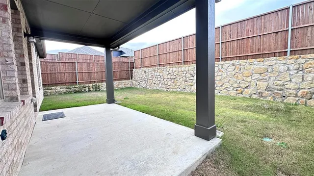 a view of a backyard with a large tree