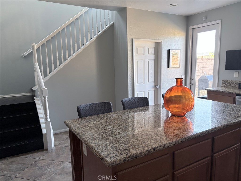 2729 Hornbeam Road Palmdale, CA 93551 - Photo 10 of 35 a kitchen with a granite countertop sink and cabinets