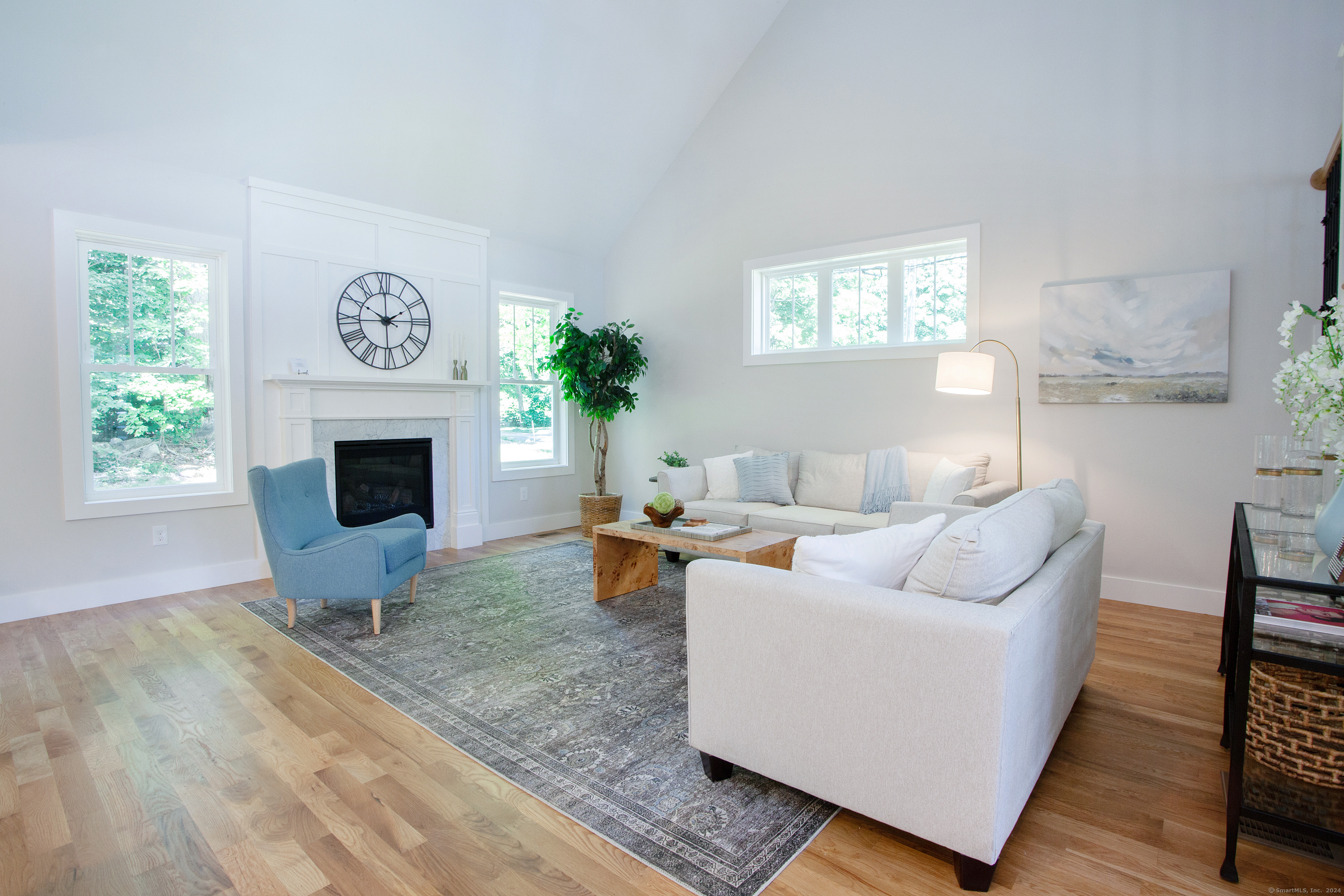 a living room with furniture a fireplace and a table