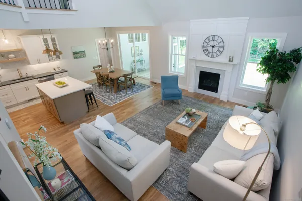 a living room with furniture fireplace and a table