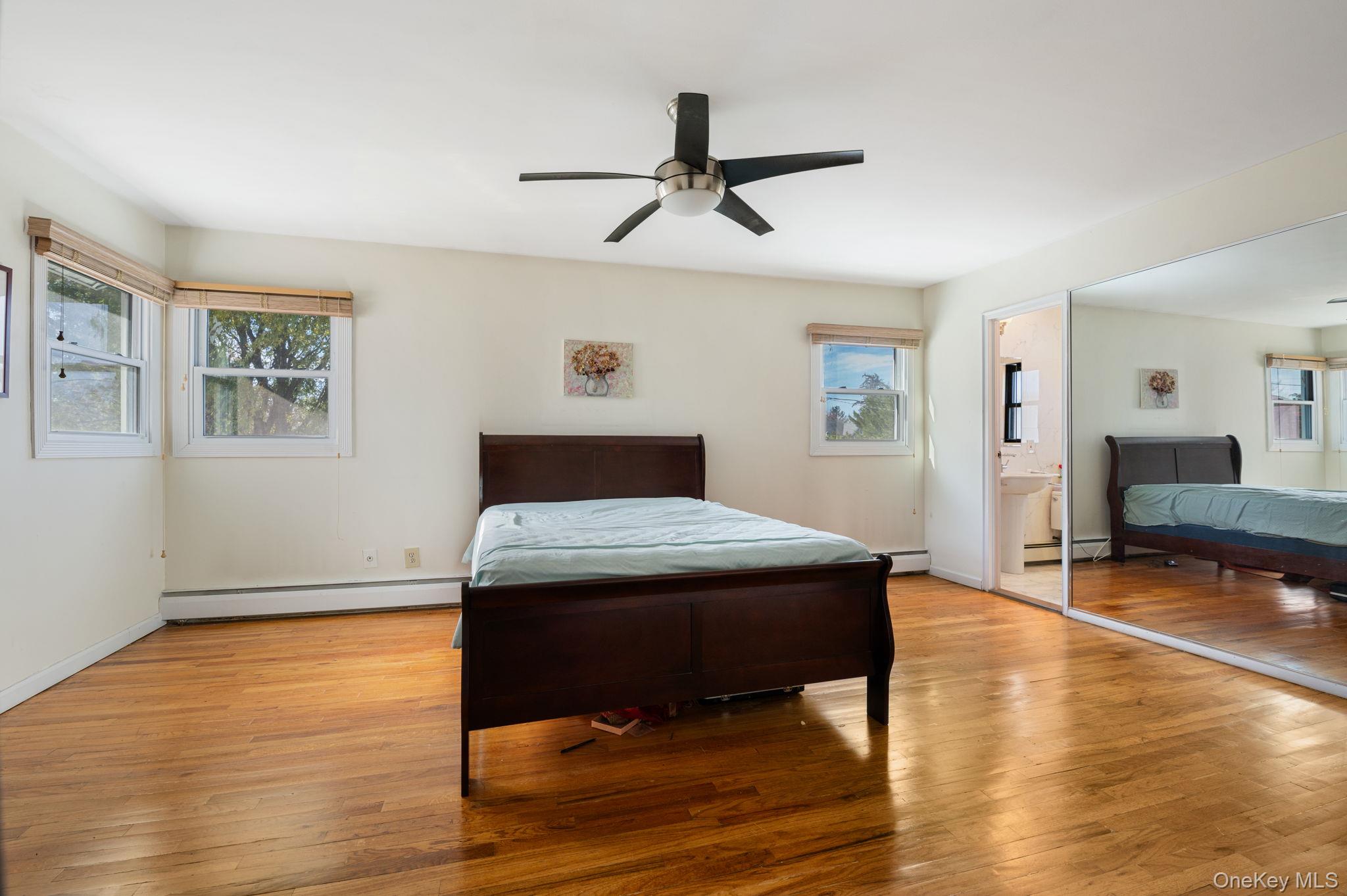 89 Nottingham Road Manhasset Hills, NY 11040 - Photo 20 of 44 a bedroom with a bed and wooden floor