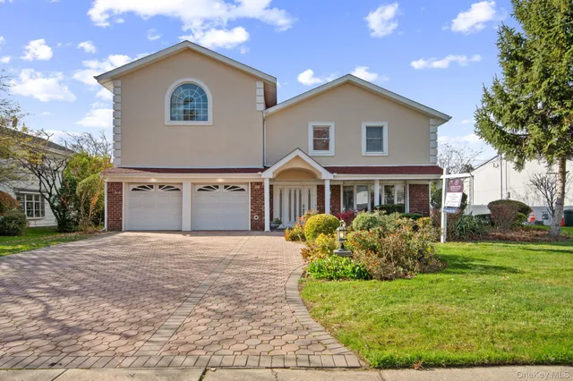 a front view of house with yard and green space
