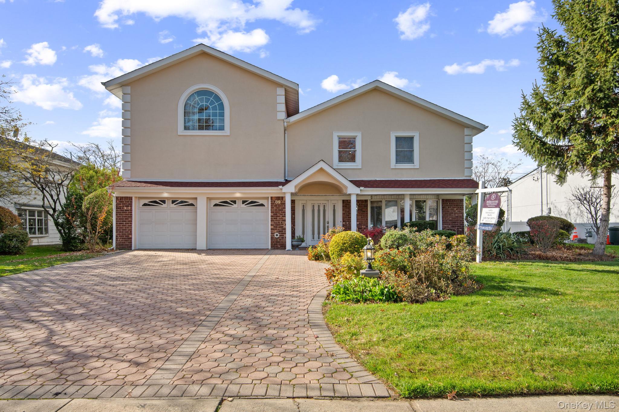 89 Nottingham Road Manhasset Hills, NY 11040 - Photo 2 of 44 a front view of house with yard and green space