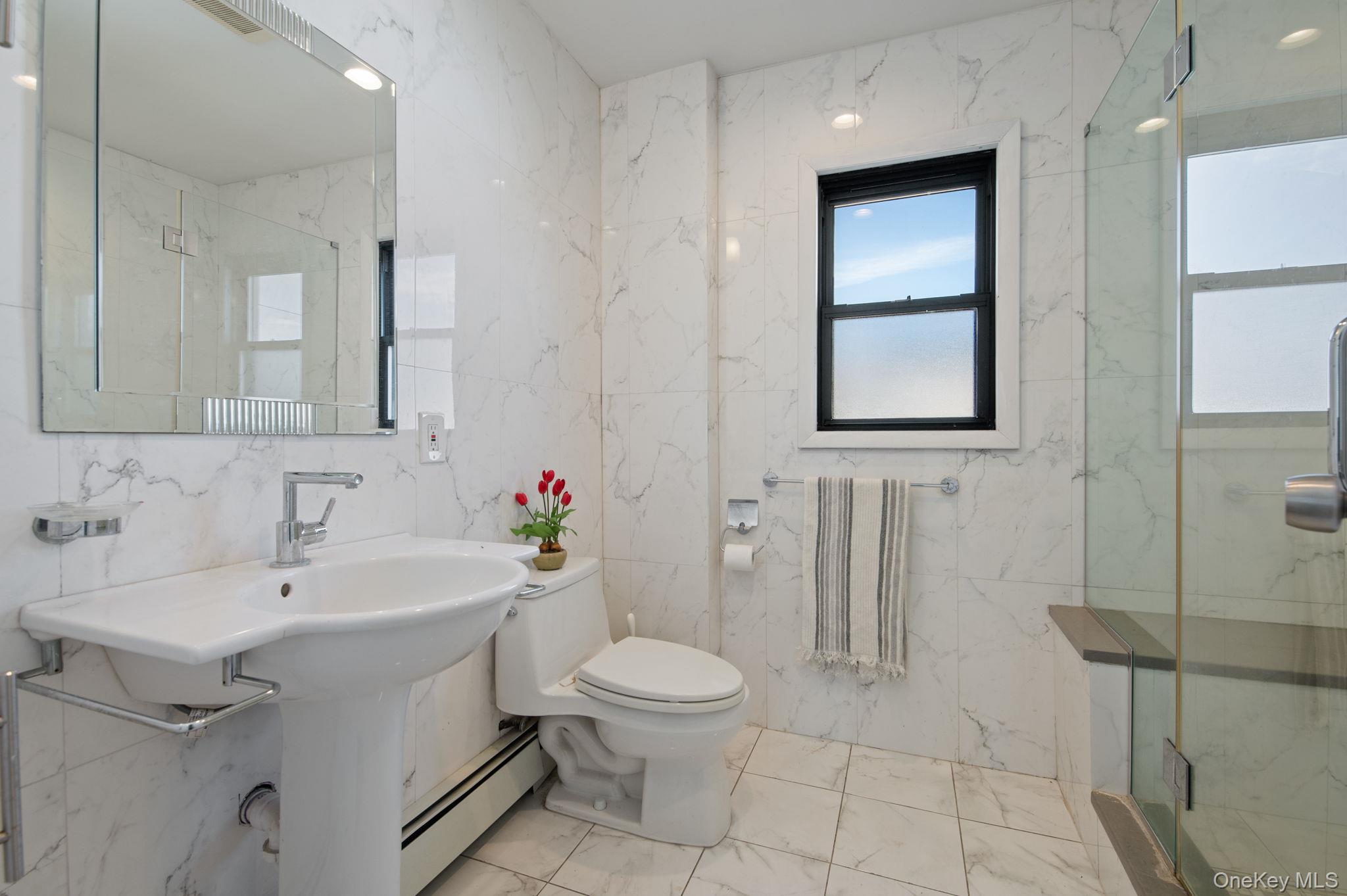 89 Nottingham Road Manhasset Hills, NY 11040 - Photo 21 of 44 a bathroom with a toilet sink and mirror