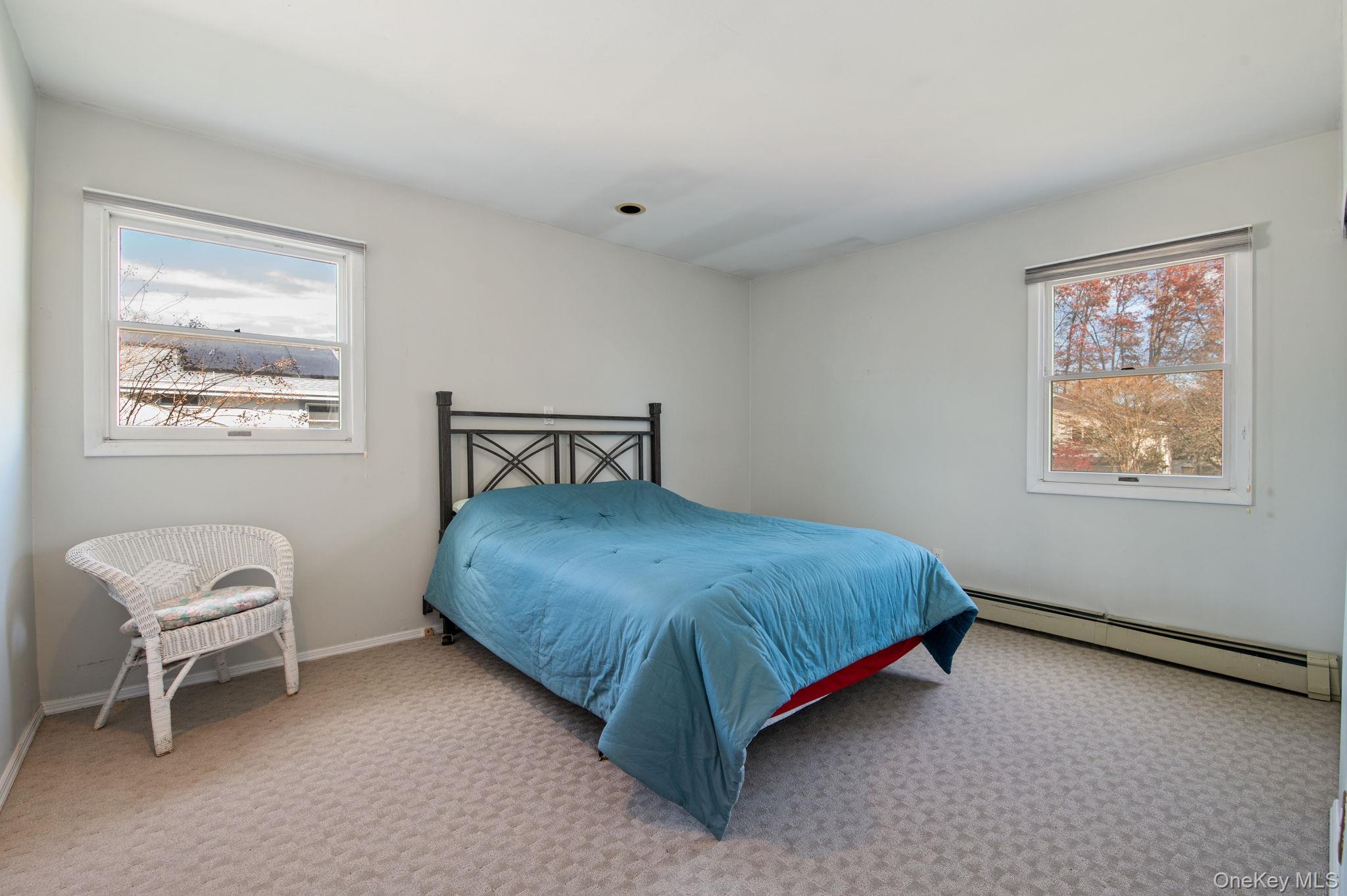 89 Nottingham Road Manhasset Hills, NY 11040 - Photo 25 of 44 a bedroom with a bed and window