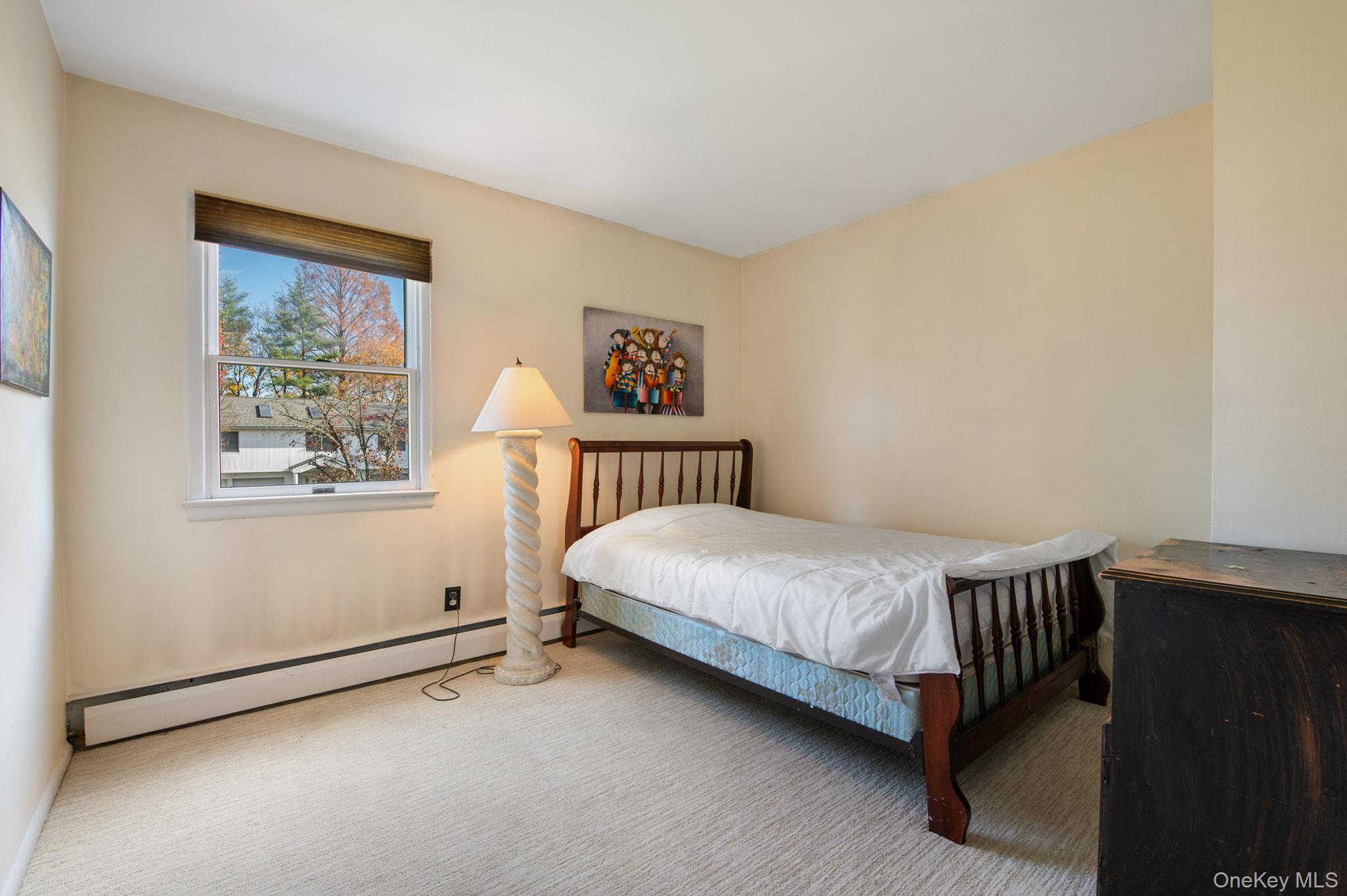 89 Nottingham Road Manhasset Hills, NY 11040 - Photo 26 of 44 a bedroom with a bed and window