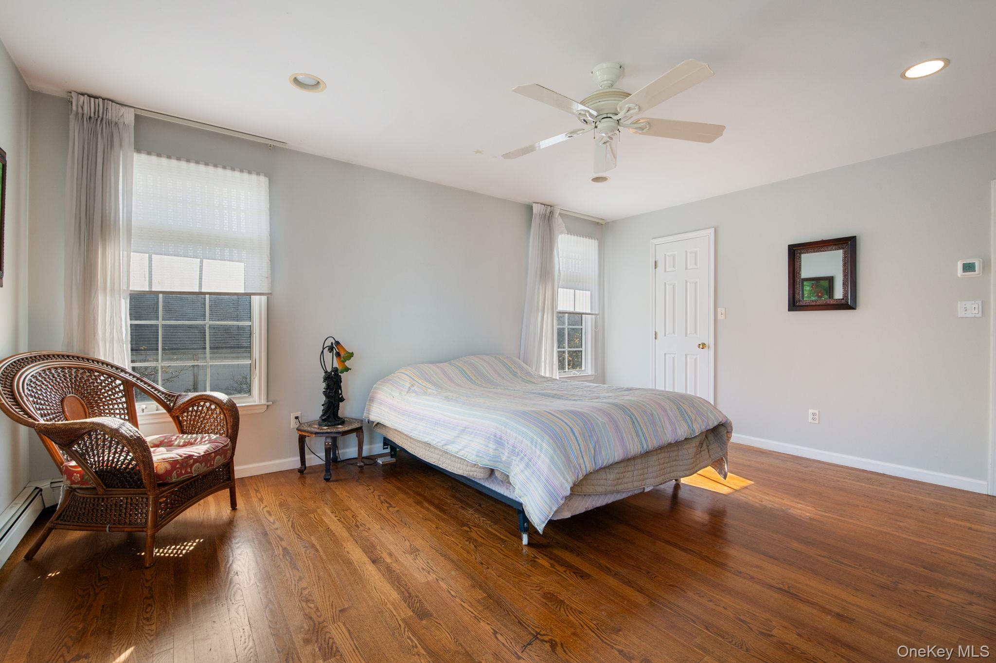 89 Nottingham Road Manhasset Hills, NY 11040 - Photo 28 of 44 a bedroom with a bed and wooden floor