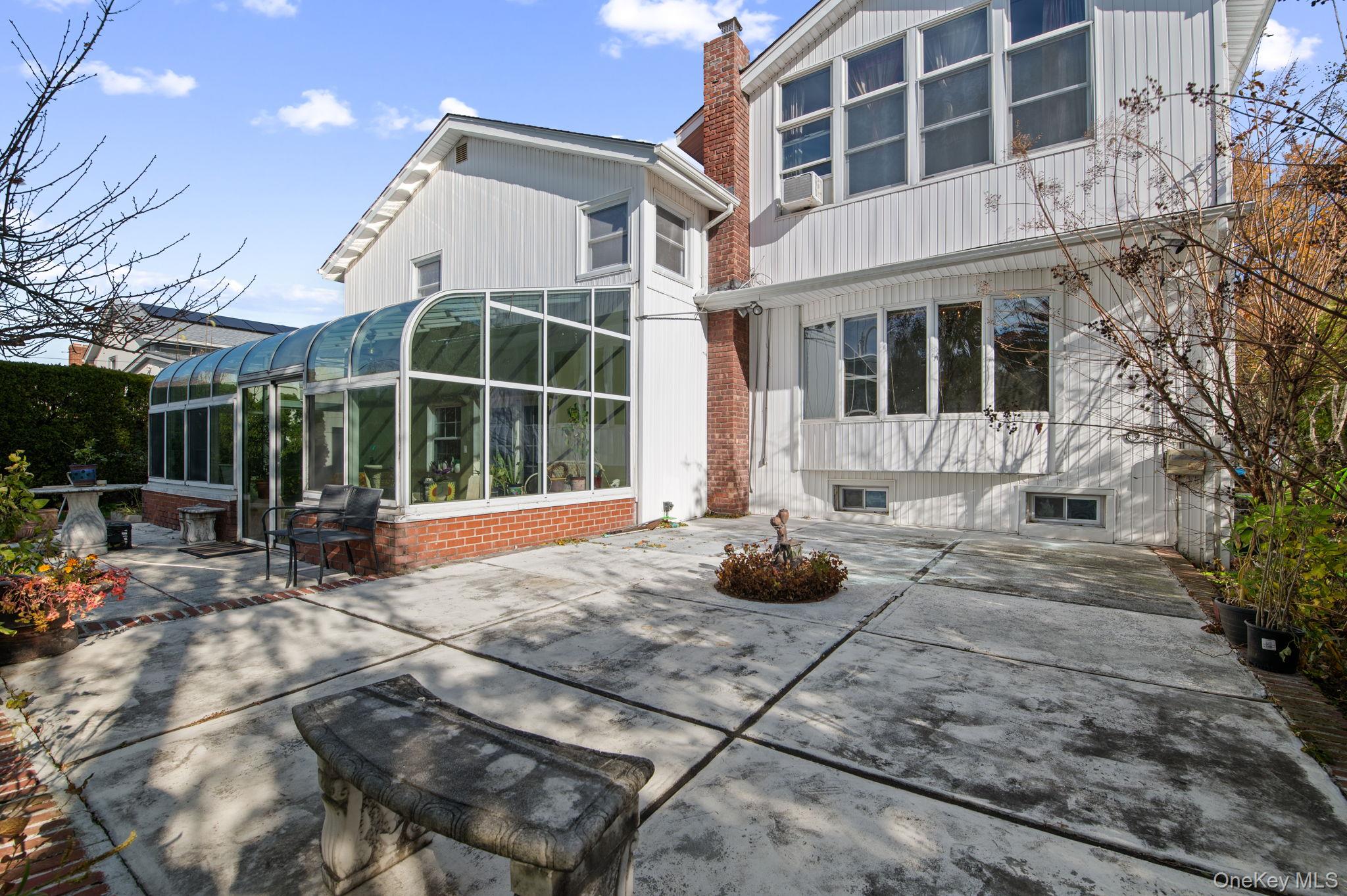 89 Nottingham Road Manhasset Hills, NY 11040 - Photo 33 of 44 a view of a house with backyard and sitting area