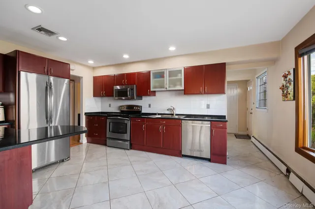 a kitchen with stainless steel appliances granite countertop a refrigerator and a stove top oven