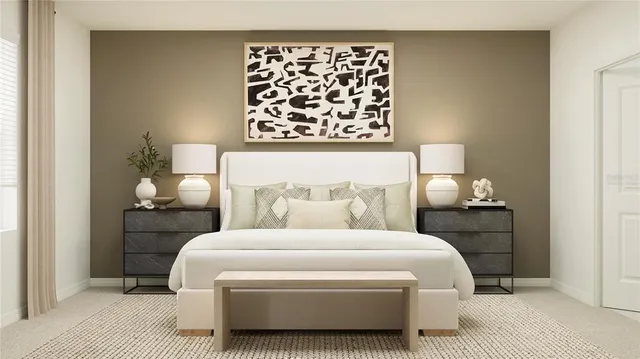 a bedroom with a bed and a lamp on dresser