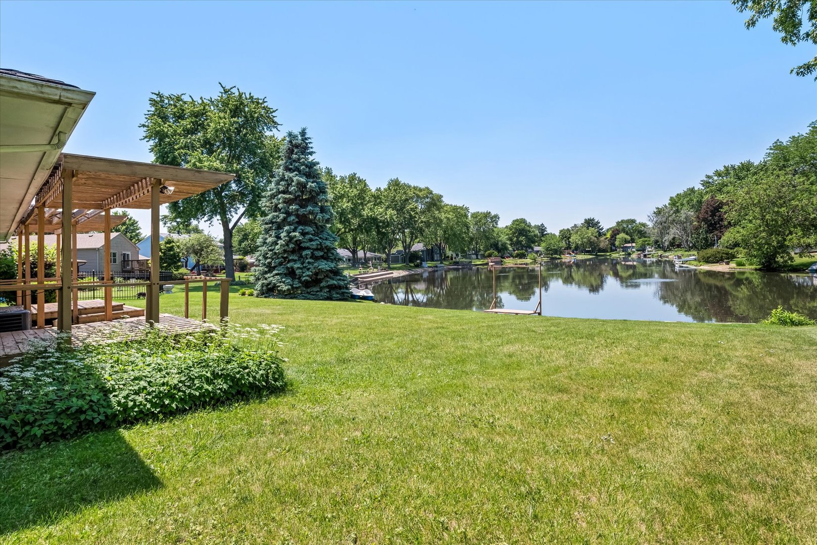 33 Somerset Road Montgomery, IL 60538 - Photo 2 of 17 a view of a lake with a garden