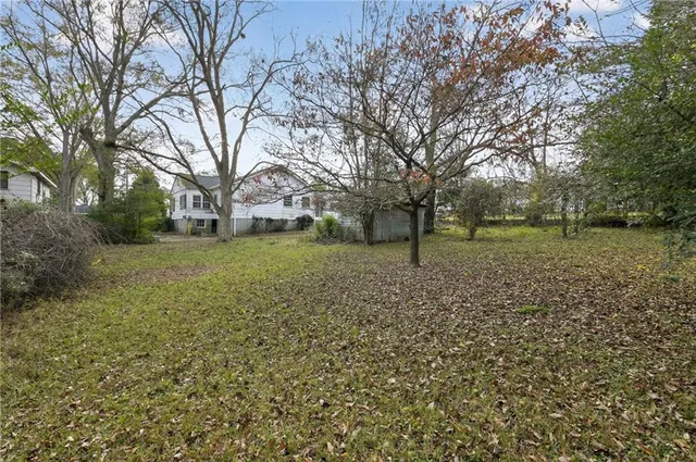 a view of a yard with a house in the background