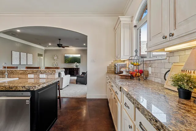 a spacious bedroom with a bed and a flat screen tv