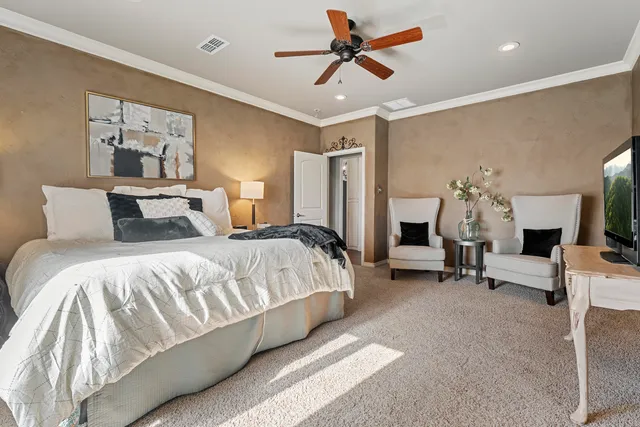 a bedroom with a bed and a chair