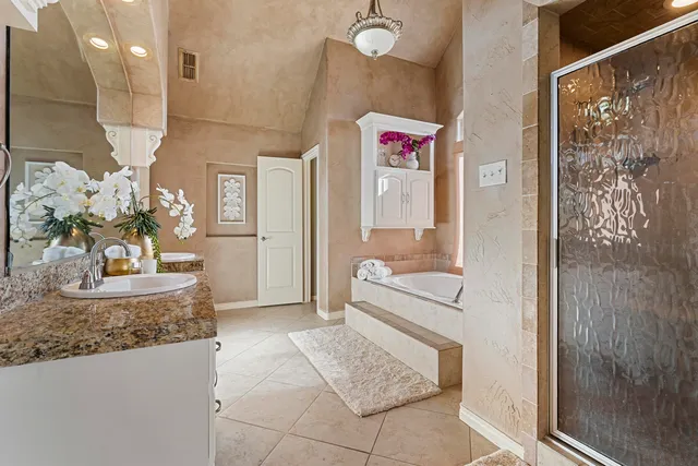 a bathroom with a granite countertop toilet a sink and a bathtub