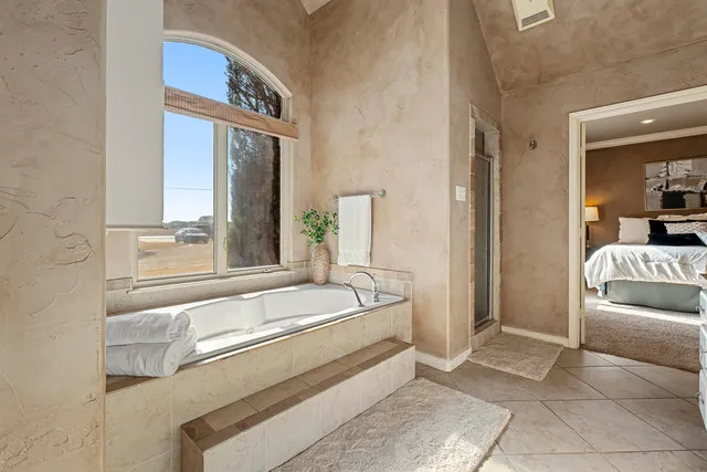 a bedroom with a bed and a potted plant