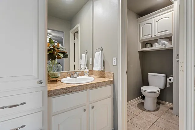 a living room with furniture and a gym machine with rug