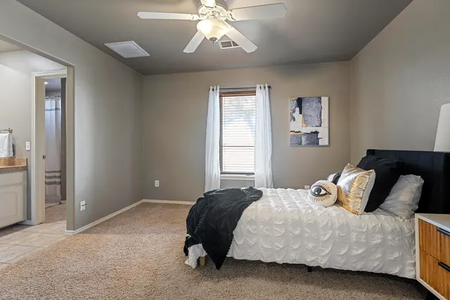 a kitchen with granite countertop white cabinets and white appliances