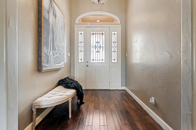 a living room with fireplace furniture and a large window