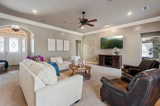 a open kitchen with stainless steel appliances granite countertop a dining table chairs refrigerator and sink