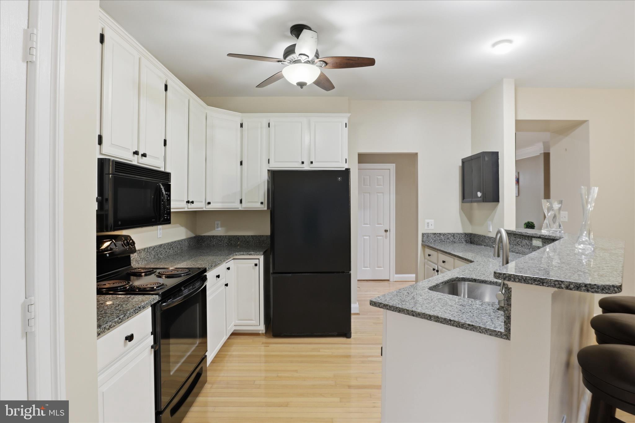 1319 Sundial Drive Reston, VA 20194 - Photo 13 of 49 a kitchen with granite countertop a refrigerator a sink and dishwasher