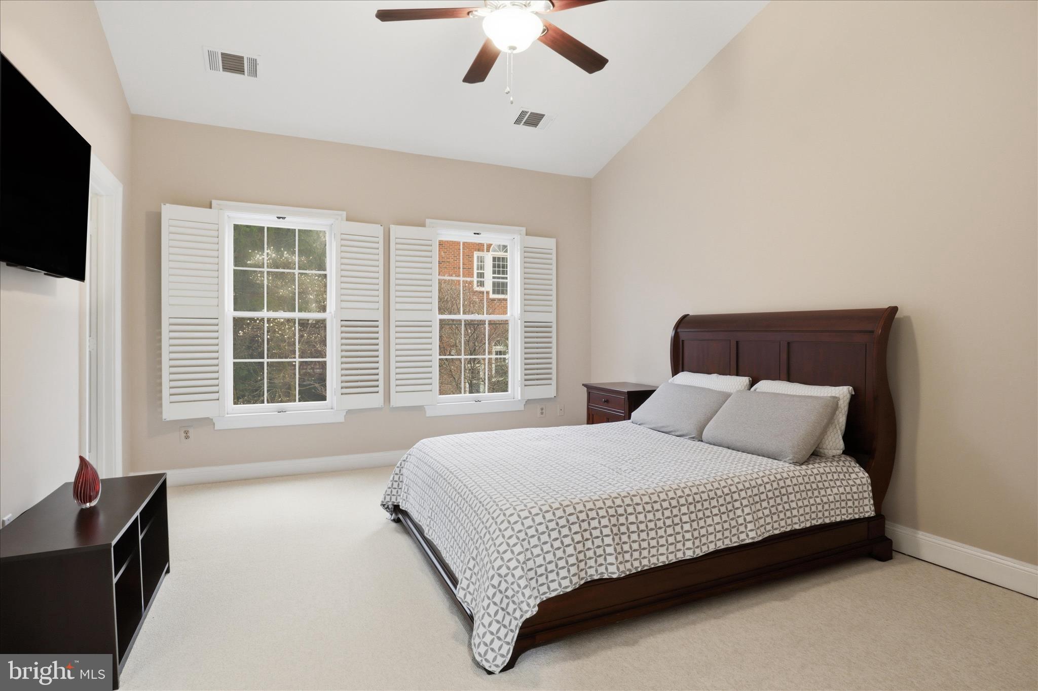 1319 Sundial Drive Reston, VA 20194 - Photo 15 of 49 a bedroom with a large bed and a flat tv screen on dresser
