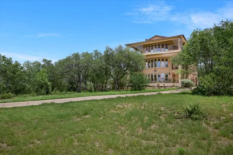 a view of a big yard with large trees