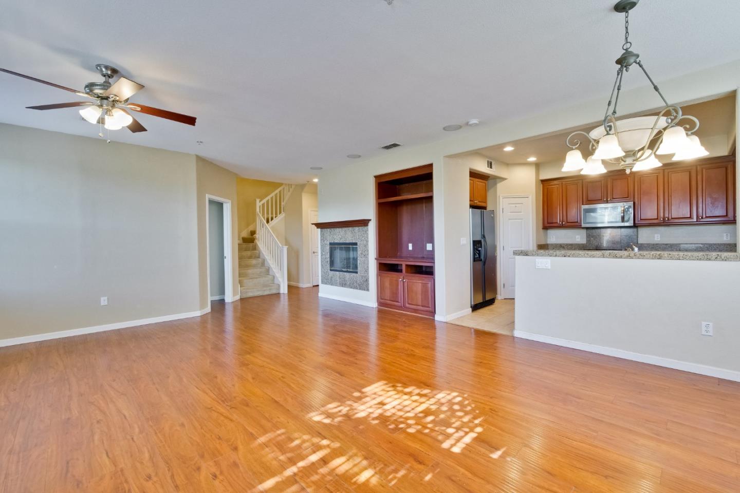 811 Joree Lane San Ramon, CA 94582 - Photo 9 of 43 a view of a living room a kitchen with a stove and wooden floor