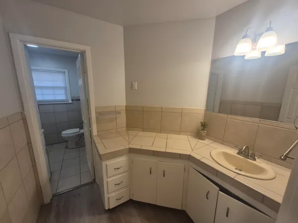 a spacious bathroom with a double vanity sink and mirror