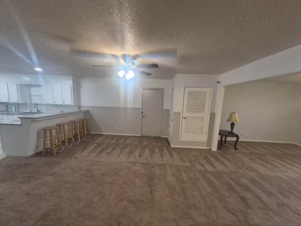 a view of a kitchen with a sink and a window